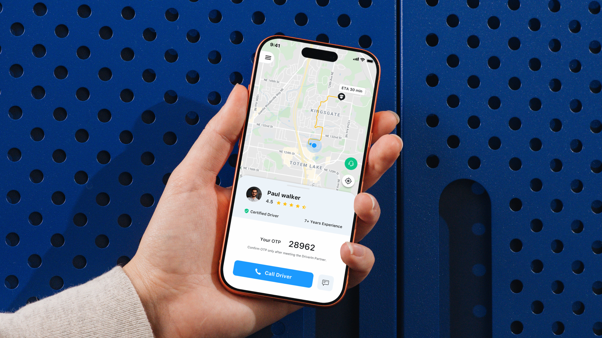 DriverIn app — live ride tracking with driver details and OTP confirmation, held in hand